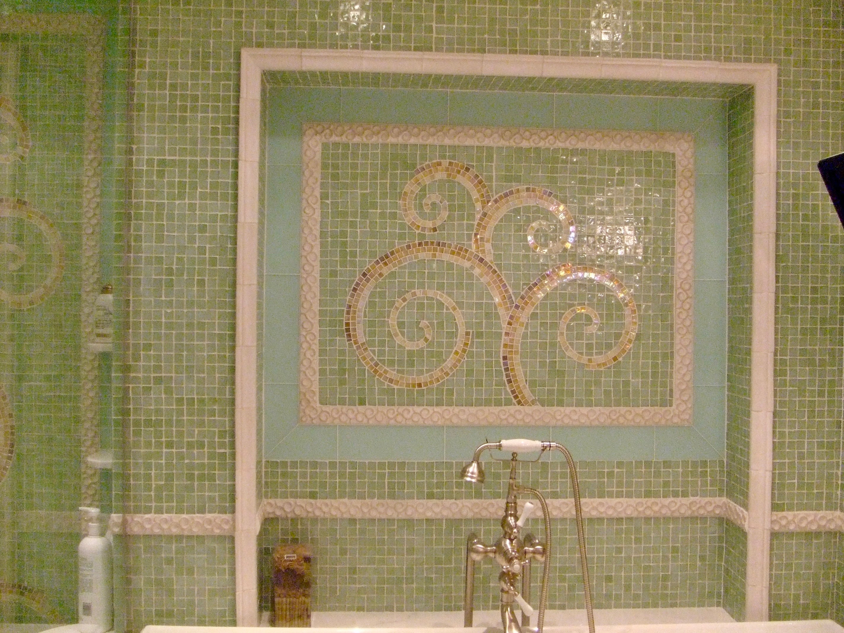 Decorative mosaic tile wall with intricate patterns in a bathroom setting.