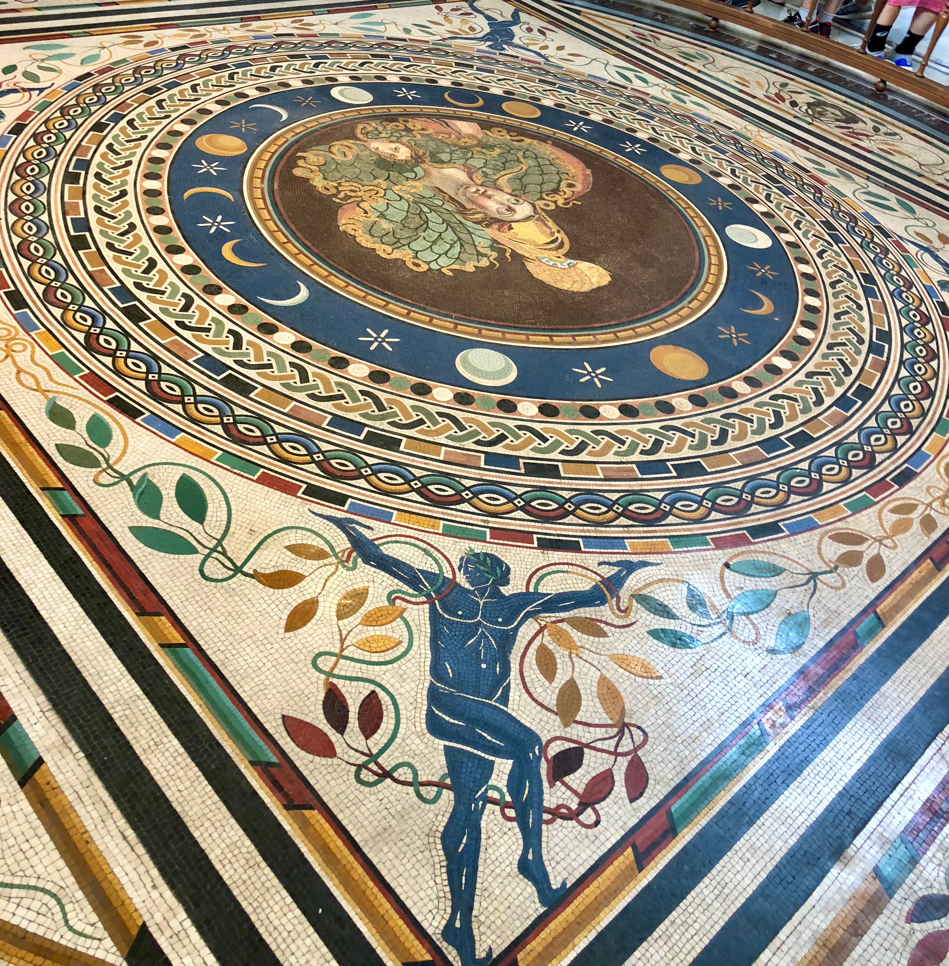 Decorative mosaic floor with classical figures and celestial elements