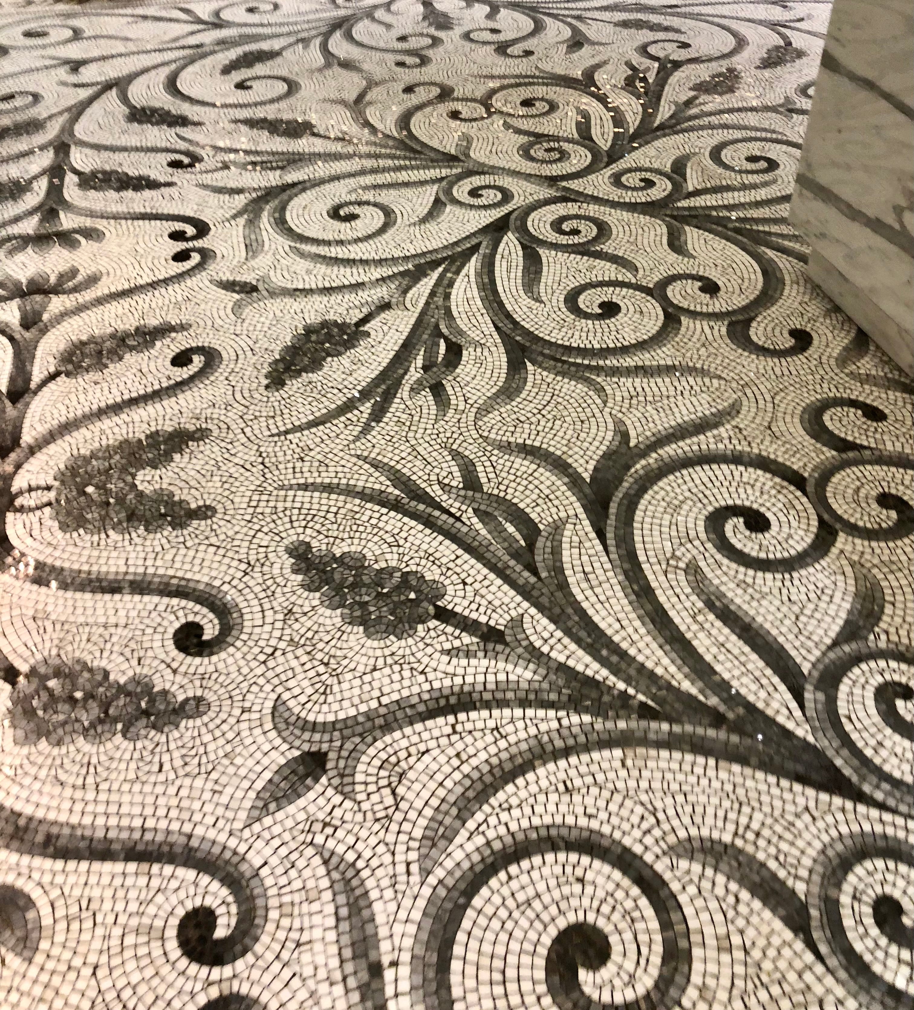 Close-up of a decorative mosaic floor with intricate patterns.
