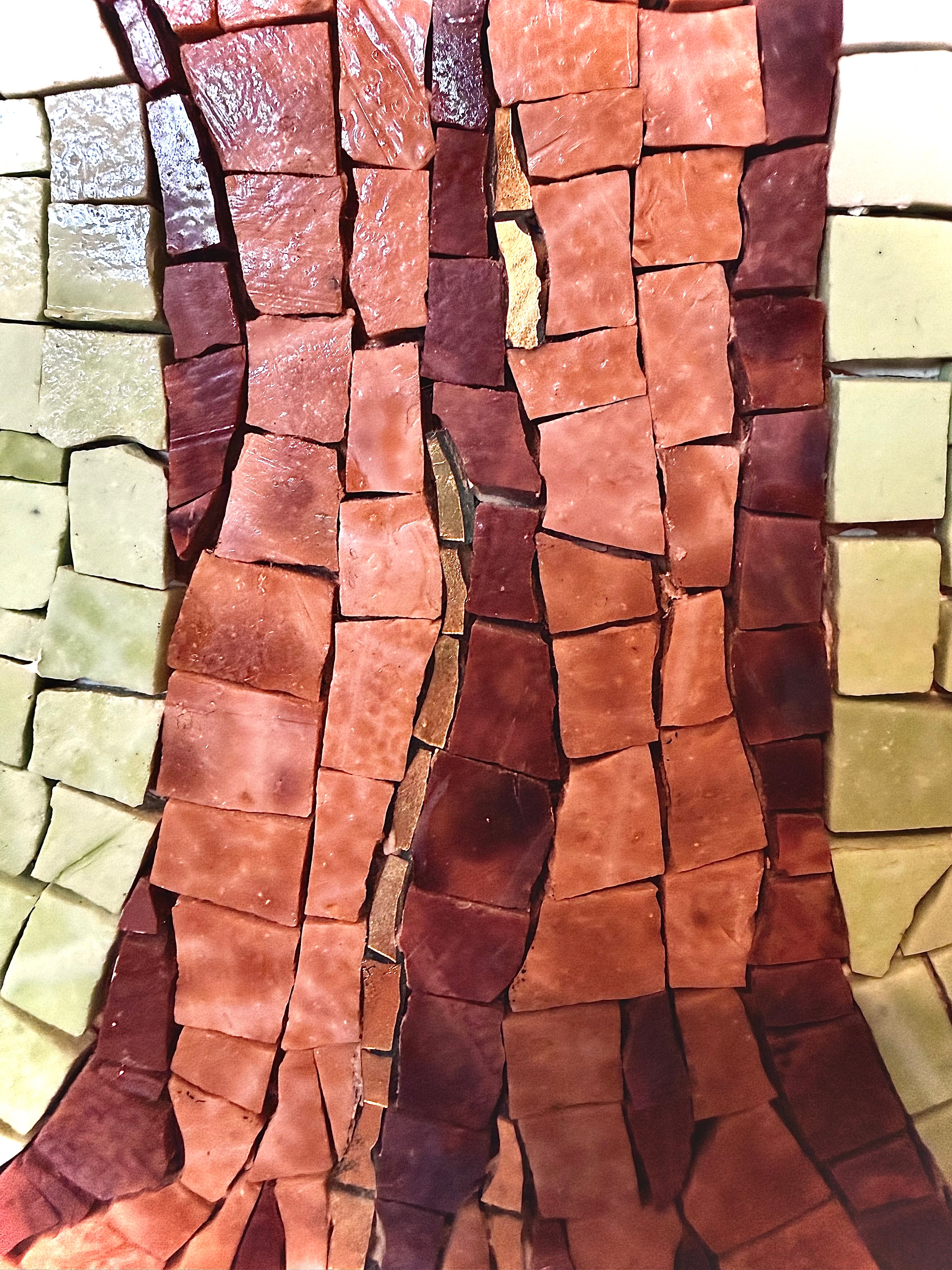 Mosaic wall art with rectangular tiles in brown, beige, and green.