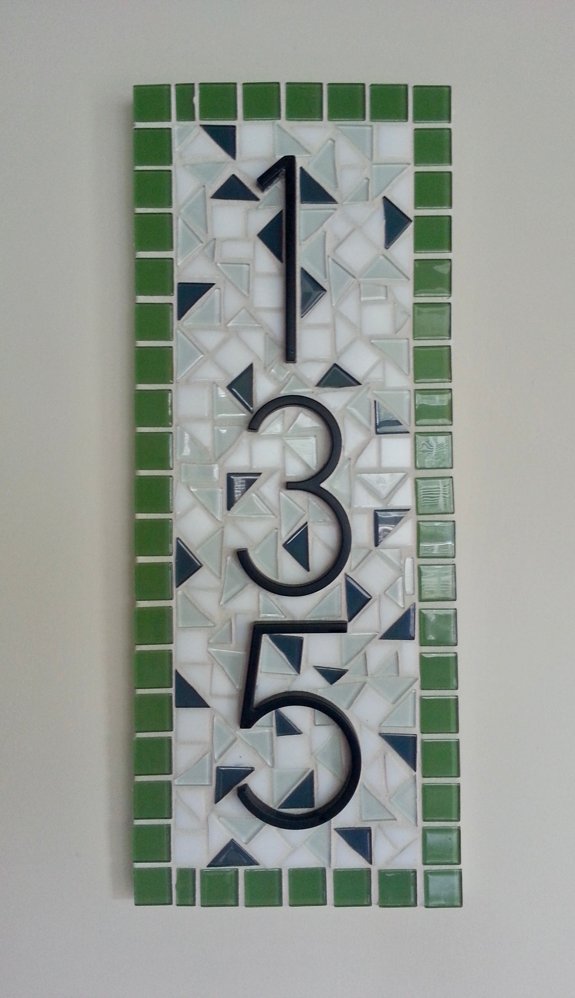 Mosaic house number '35' on a tiled background