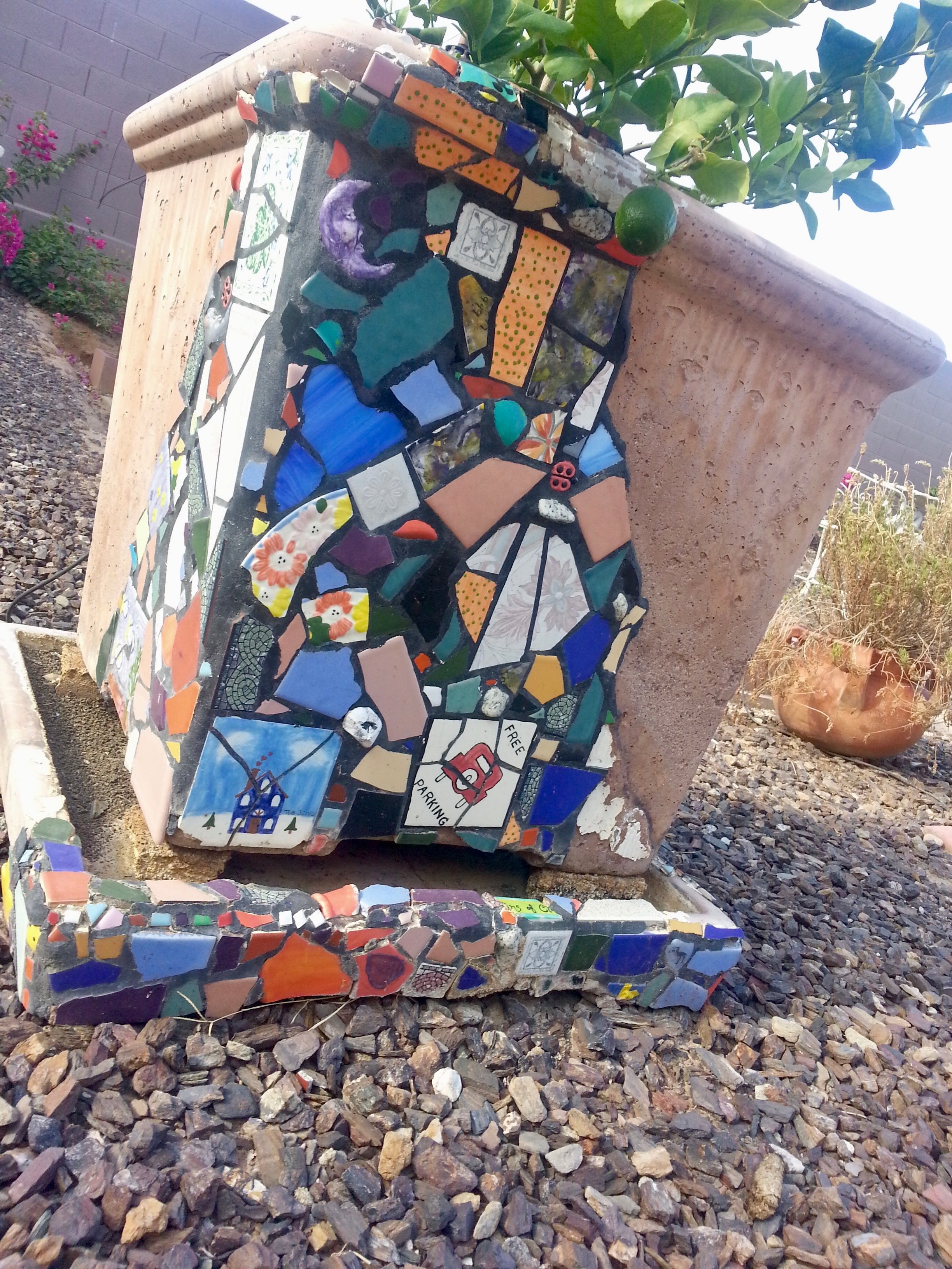 Mosaic art piece on a stone surface outdoors