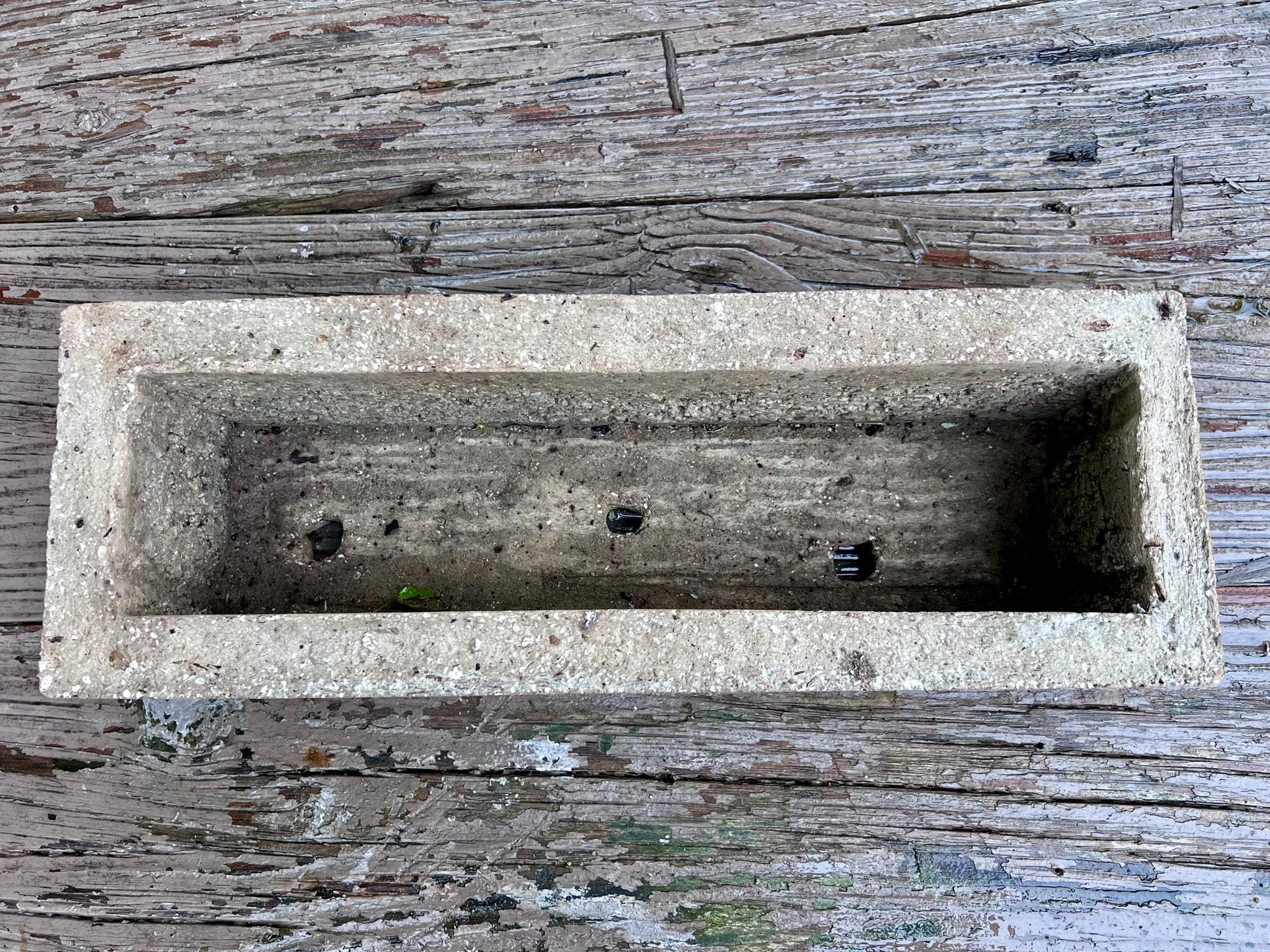 Concrete planter box on a wooden surface