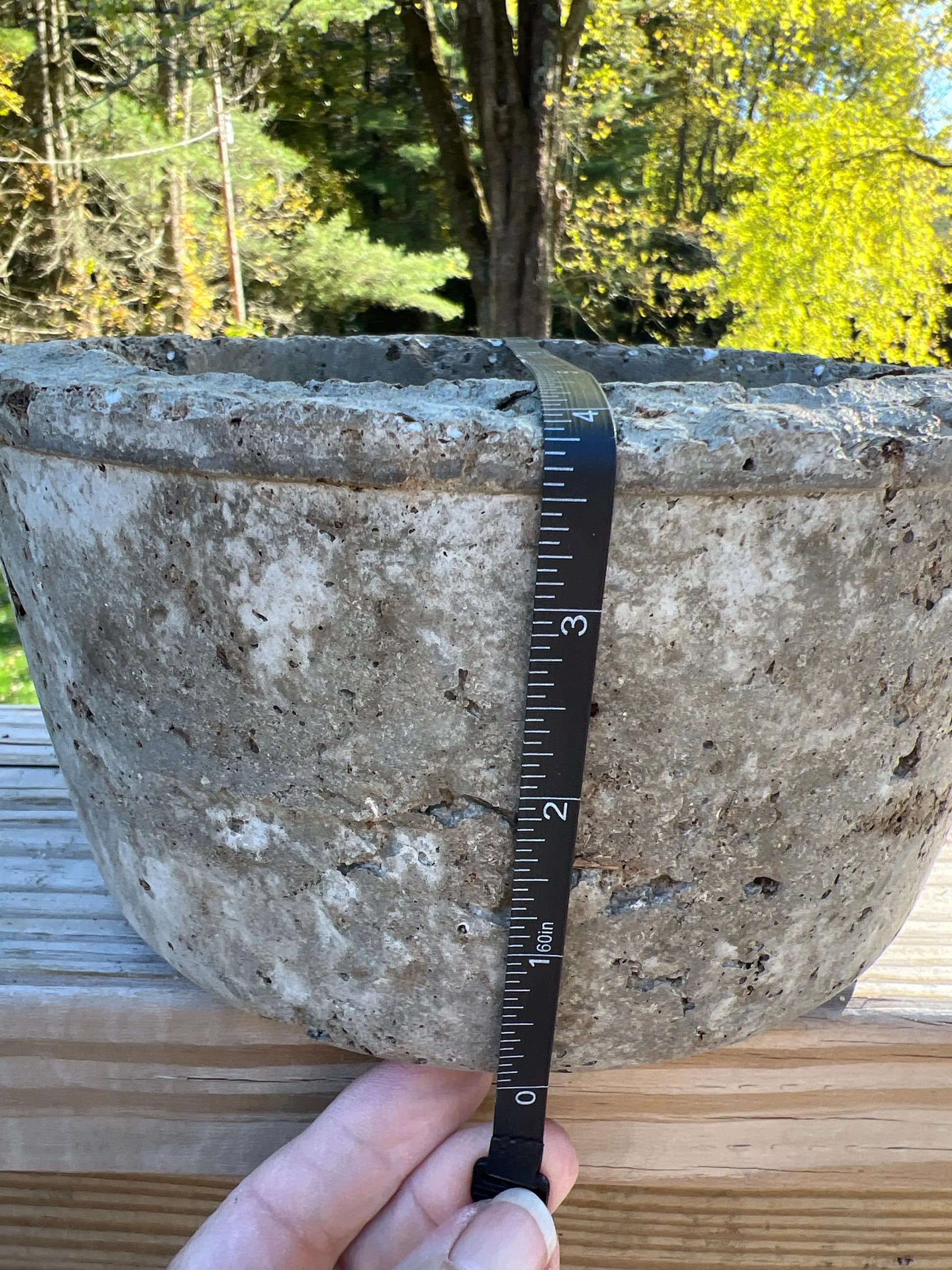 Concrete basin with a ruler for scale against a natural background