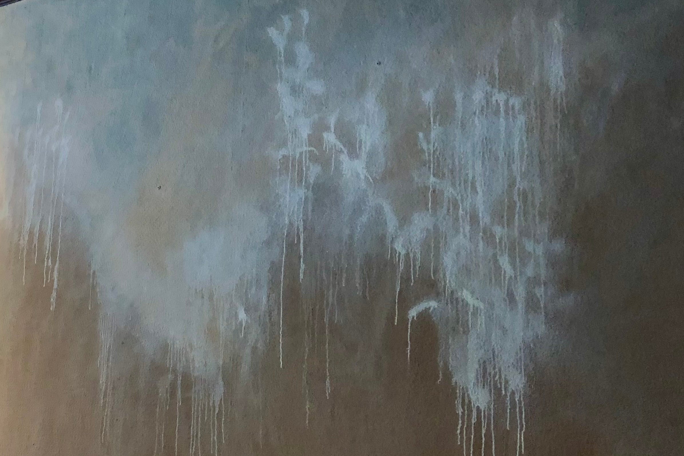 Abstract art with white paint drips on a textured brown background